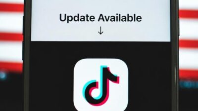 A smartphone screen showing the TikTok app updating, with a US flag - via eurAI