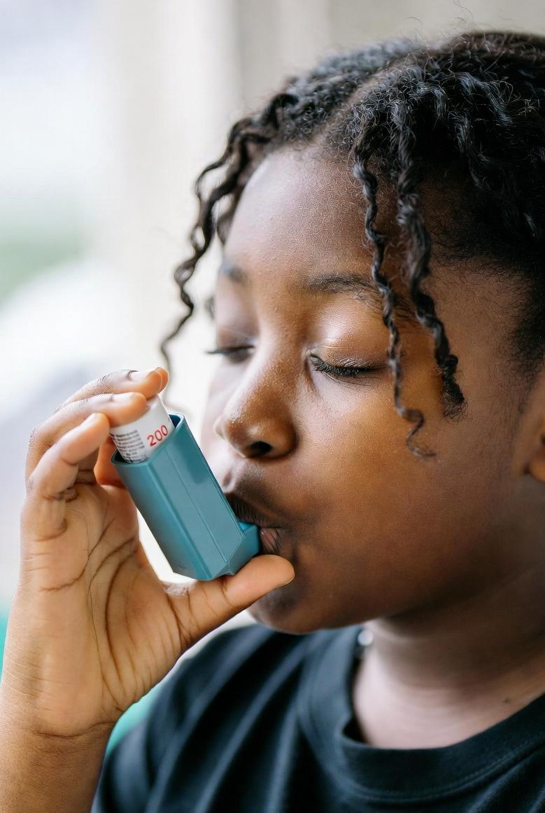 A teenage female using an asthma inhaler - via eurAI