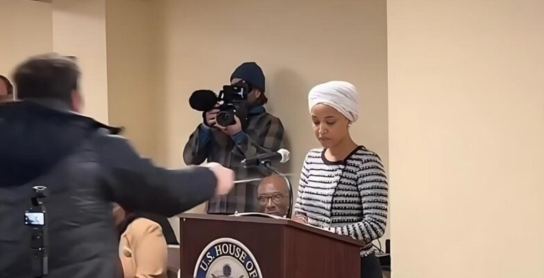 Ilhan Omar (being sprayed by unknown liquid) - screenshot