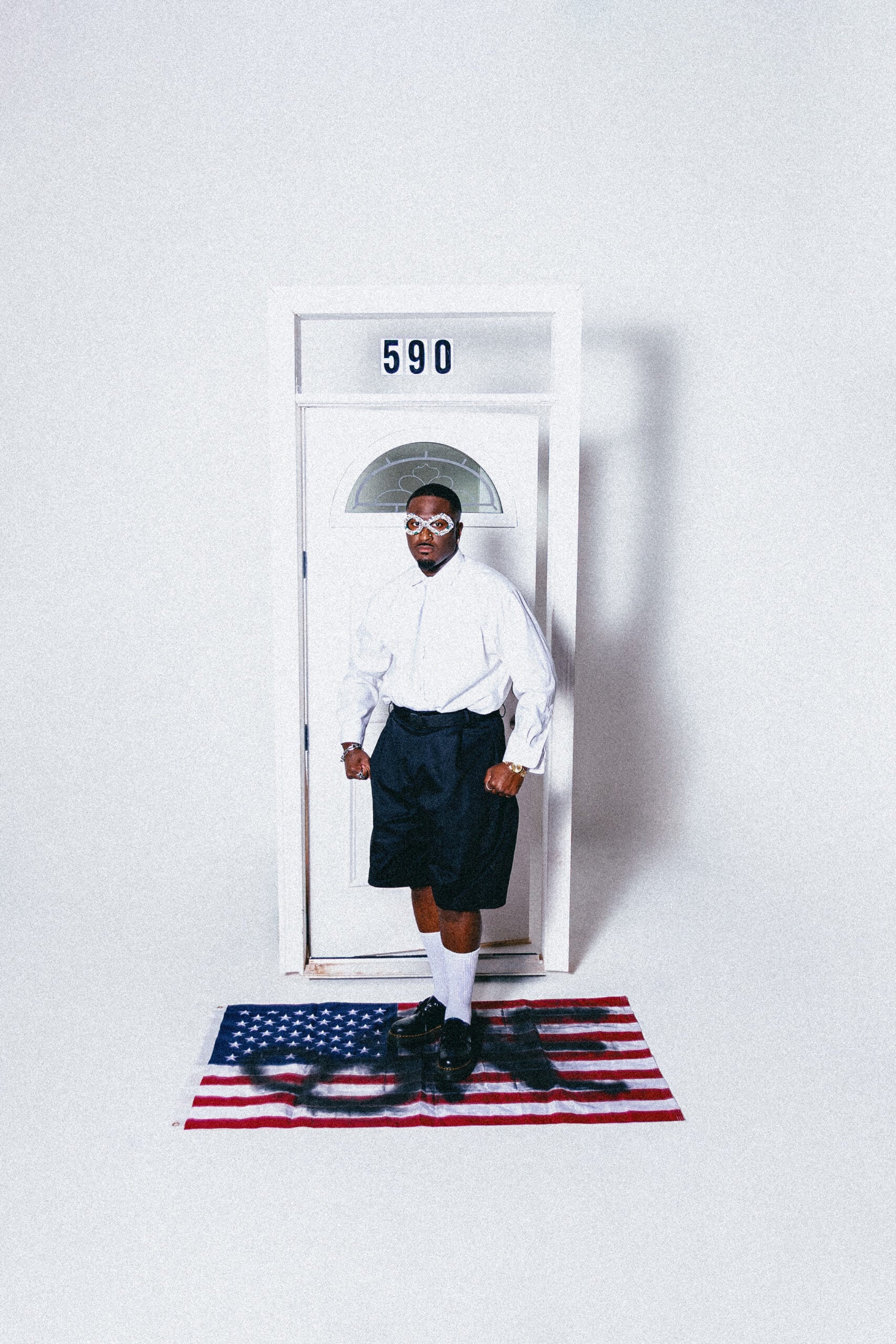 Ben Reilly standing on an American flag rug in a stylized full body portrait