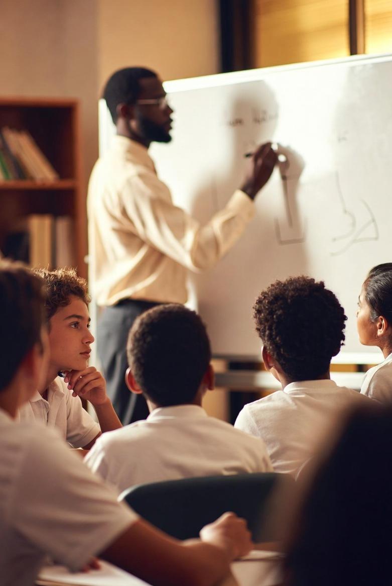 African American (male) teacher in schoolroom - via eurAI