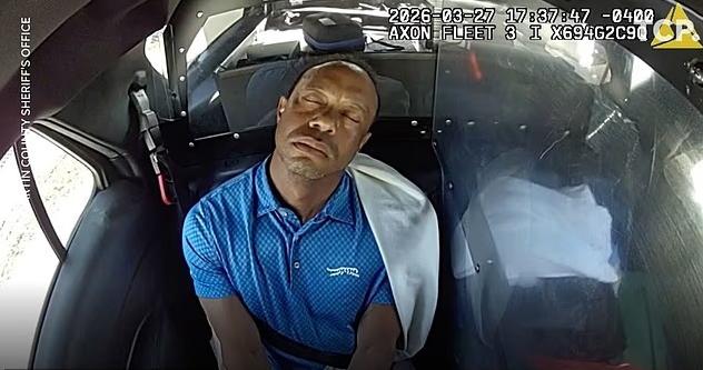 Tiger Woods appeared to drift off during the short ride to the police station in Martin County, Florida - via Martin County Sheriff's Office 
