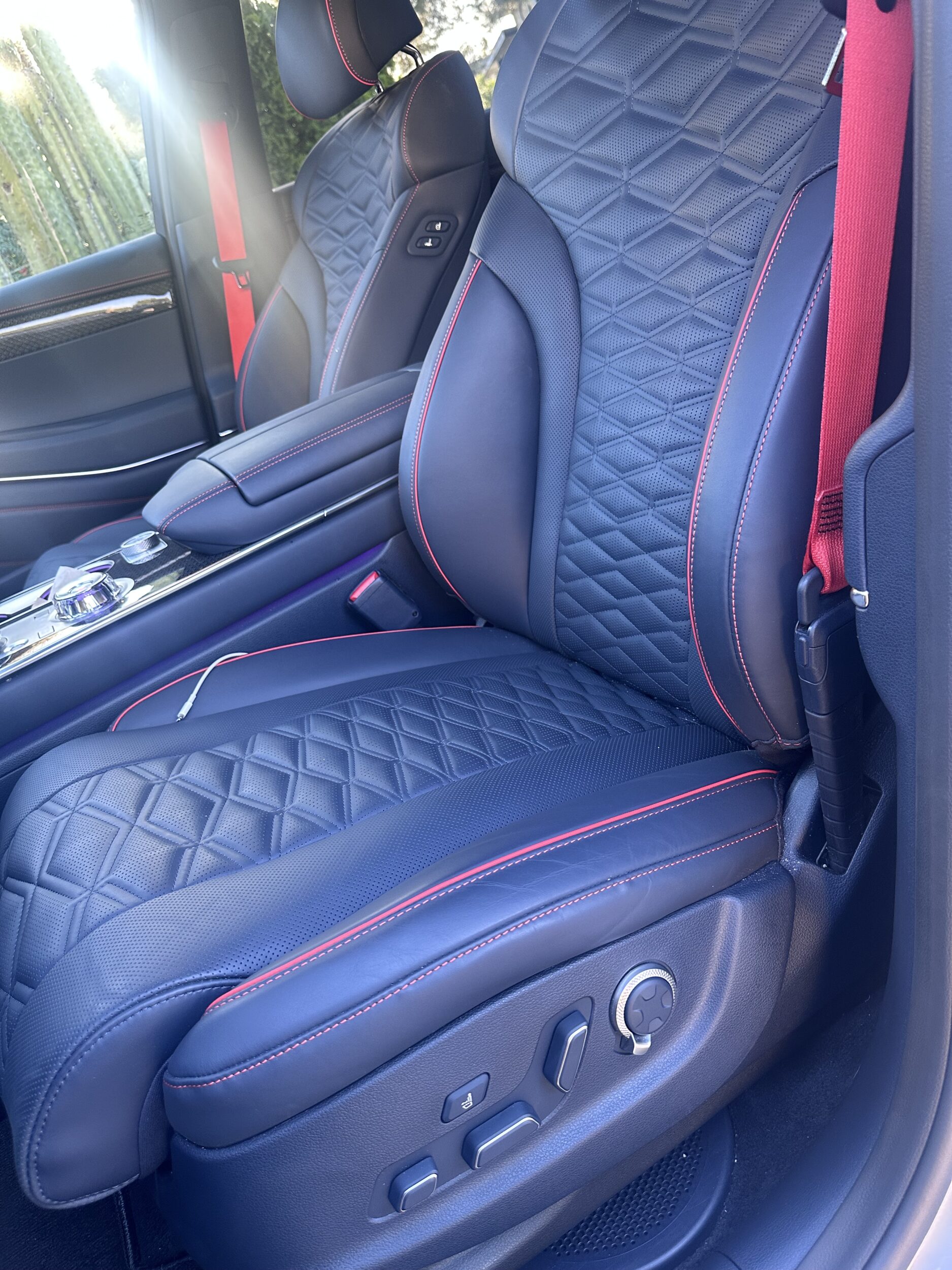dark colored car seat with red trim