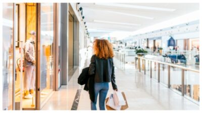 Black woman walks through a shopping center stock photo