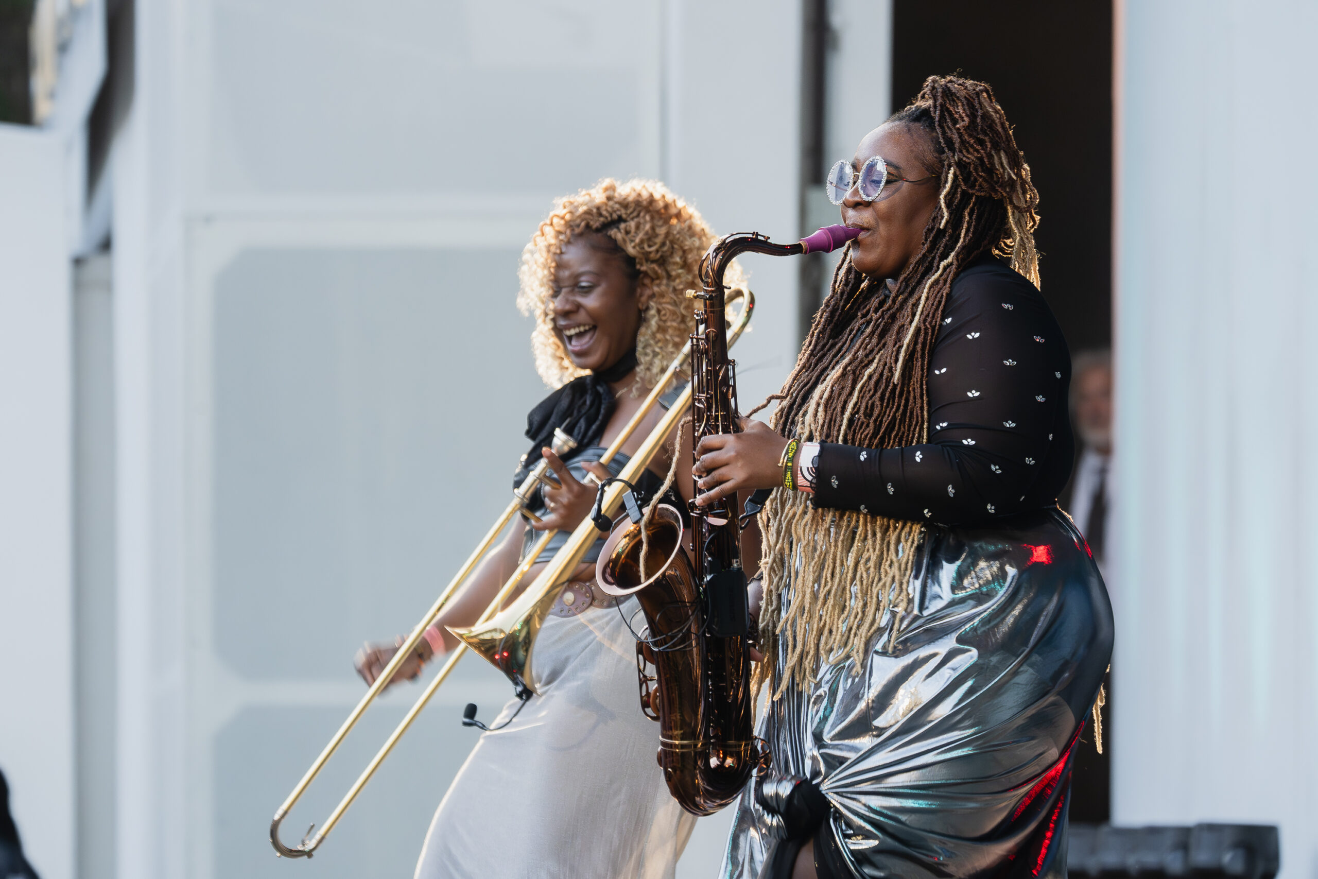 Hilaria Cacao is the trombonist, and Katy Cacao is the saxophonist in Cimafunk's band The Tribe at Blue Note Jazz Fest LA 2026. Photographs taken by Farah Sosa at the Hollywood Bowl, provided courtesy of the Los Angeles Philharmonic Association