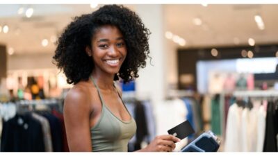 AI generate image of a Black woman using a black debit card