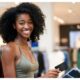 AI generate image of a Black woman using a black debit card