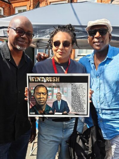 Tayo, Nelle Porter and actor Colin McFarlane both of Justice 4 Windrush with one of Tayo's donated illustrations to school