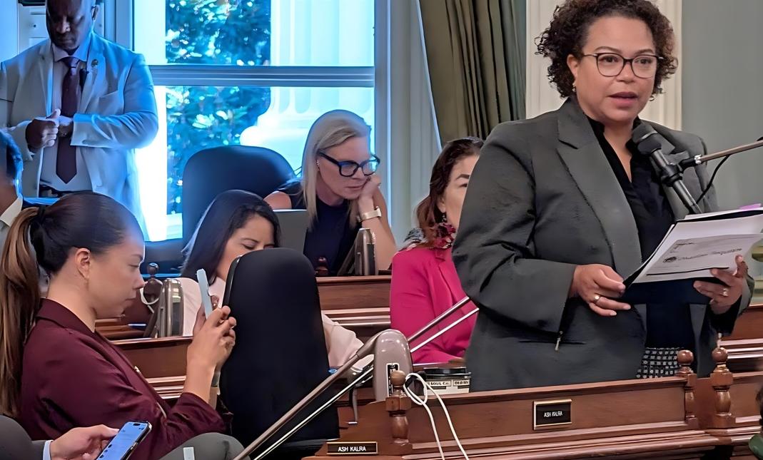 Assemblymember Mia Bonta discusses AB 801 while daughter Reina Bonta records - CBM photo by Antonio Ray Harvey