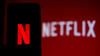 Netflix logo on smartphone and TV screen