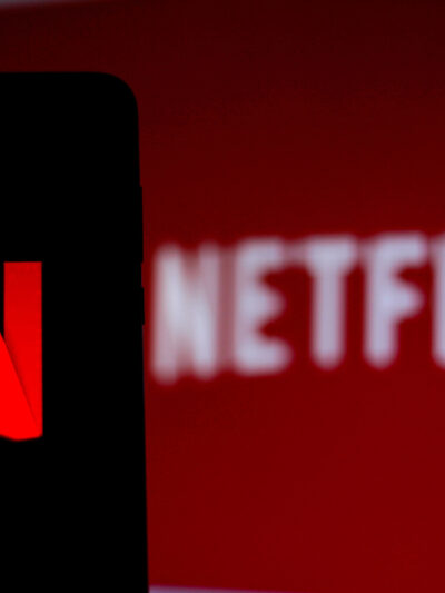 Netflix logo on smartphone and TV screen
