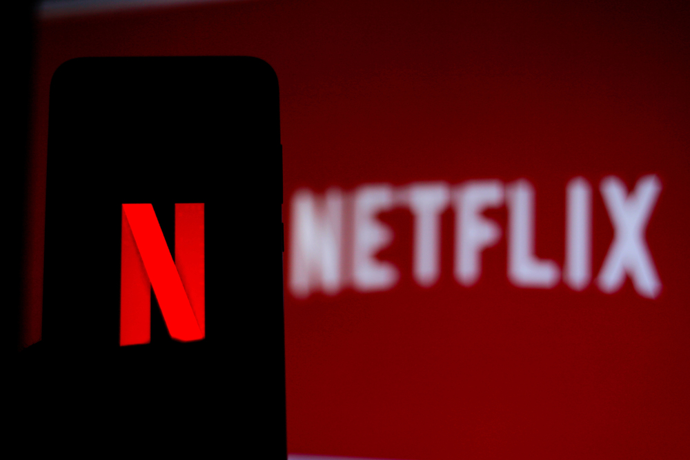 Netflix logo on smartphone and TV screen