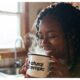 black woman drinking warm beverage AI generated