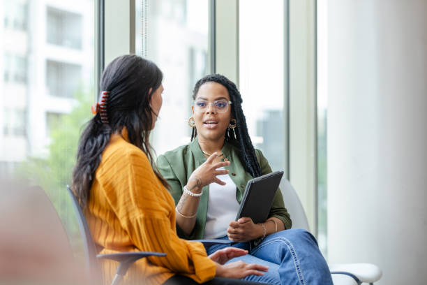 A female therapy patient listens attentively to a female therapist discuss coping strategies. Photo courtesy of TheAcclivity.com  