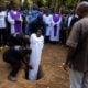African woman being buried vertically - screenshot