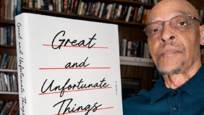 Earl Ofari Hutchinson with copy of Jason Arday's Autobiography 'Great and Unfortunate Things'