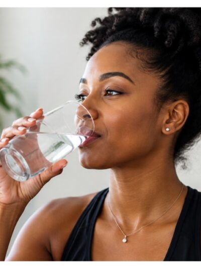 Black woman drinking glass of water