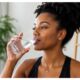 Black woman drinking glass of water