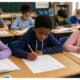 kids in classroom taking a test