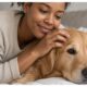 Black woman loving on her dog