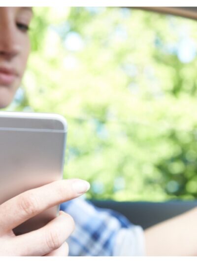 Woman In Car Texting on Mobile Phone Whilst Driving
