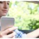 Woman In Car Texting on Mobile Phone Whilst Driving