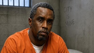 Sean Diddy Combs (in orange jail jumpsuit) - via AI