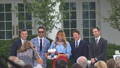 Melania Trump gets a commemorative helmet from a driver in the Rose Garden before D.C.'s first Grand Prix. (Photo by Mona Austin)