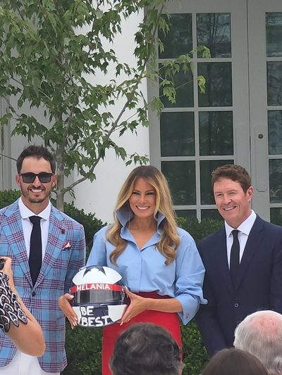Melania Trump gets a commemorative helmet from a driver in the Rose Garden before D.C.'s first Grand Prix. (Photo by Mona Austin)