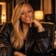 Black female rapper seated in a professional music studio setting - via eurAI.jpg
