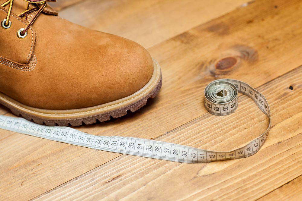 orange shoe with measuring tape