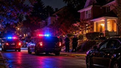 Police vehicles outside a residential home at night - via eurAI