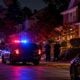 Police vehicles outside a residential home at night - via eurAI
