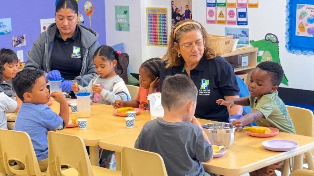 Children enjoy nutritious snacks with early childhood educators
