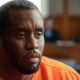 Sean Diddy Combs (with gray hair & beard) - via eurAI