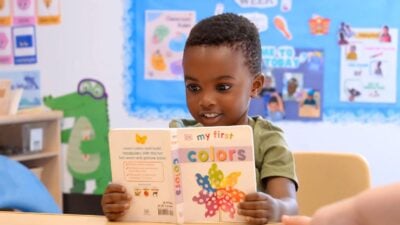 Young child explores colors through early childhood reading