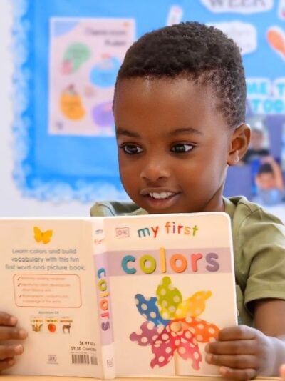 Young child explores colors through early childhood reading