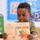 Young child explores colors through early childhood reading